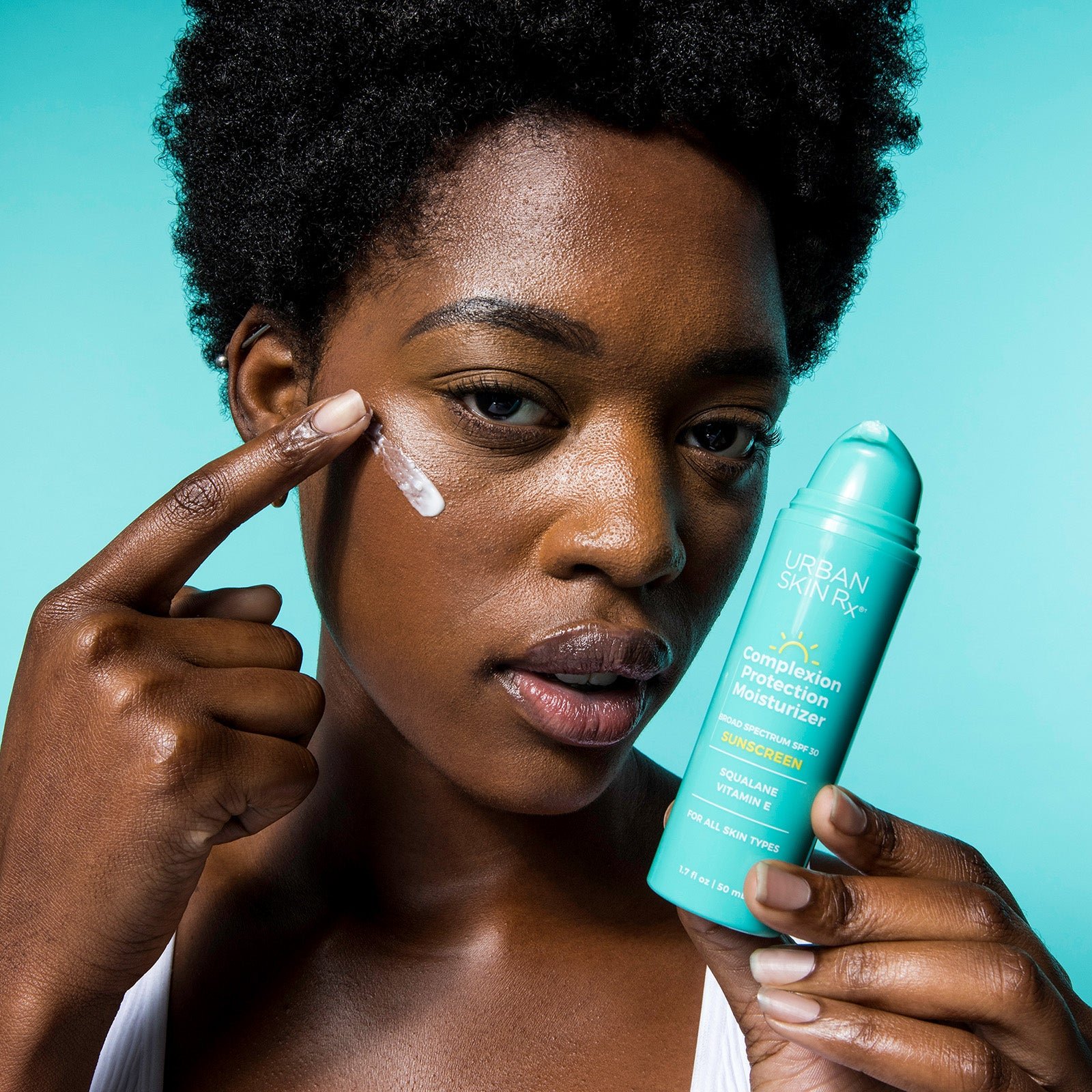 Woman applying USRx Complexion Protection SPF30 Moisturizer to her face